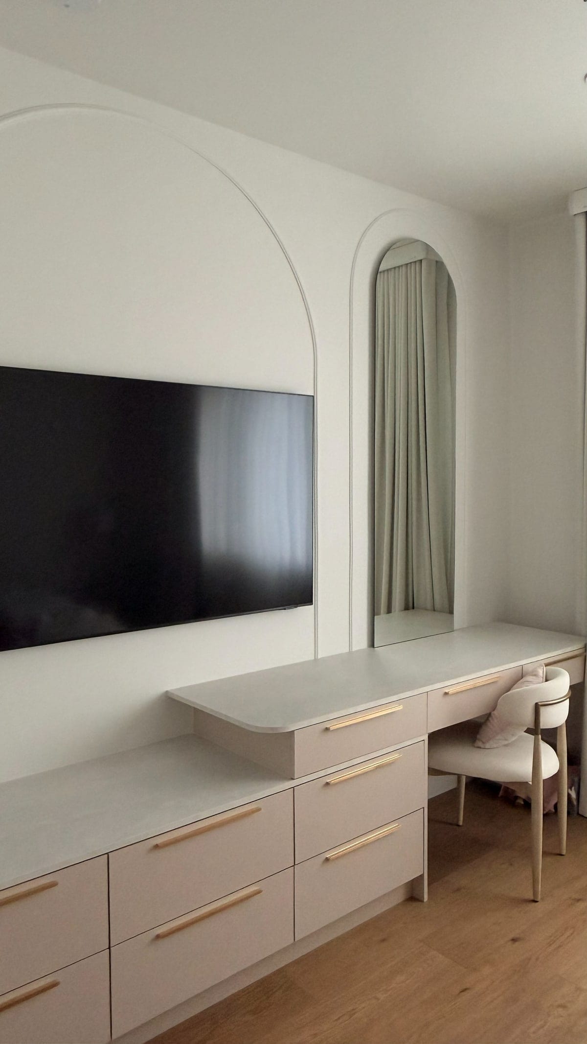 Built-in dresser and cabinetry fitted into a bedroom alcove