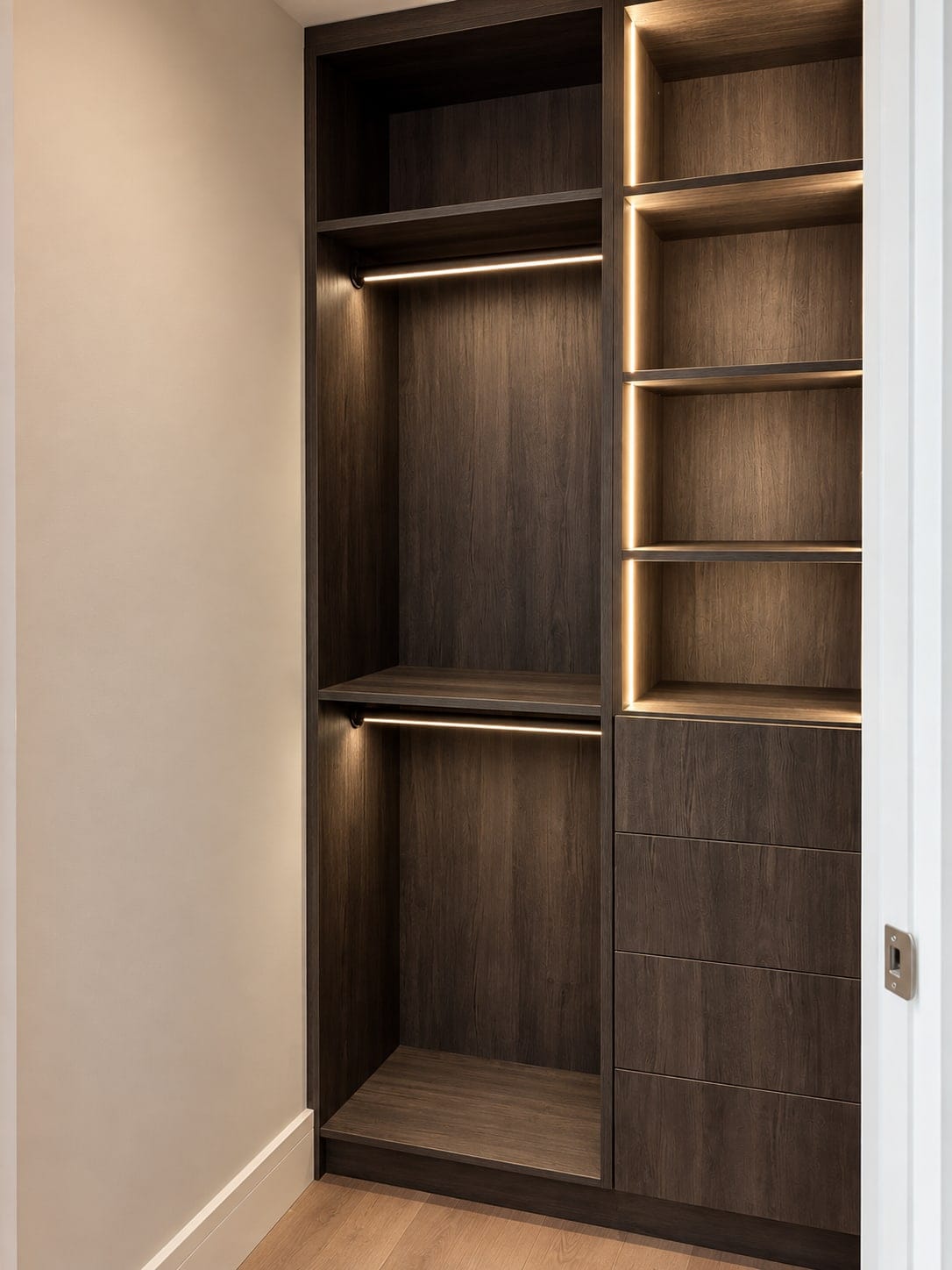 Dark closet with lit open shelving and drawers